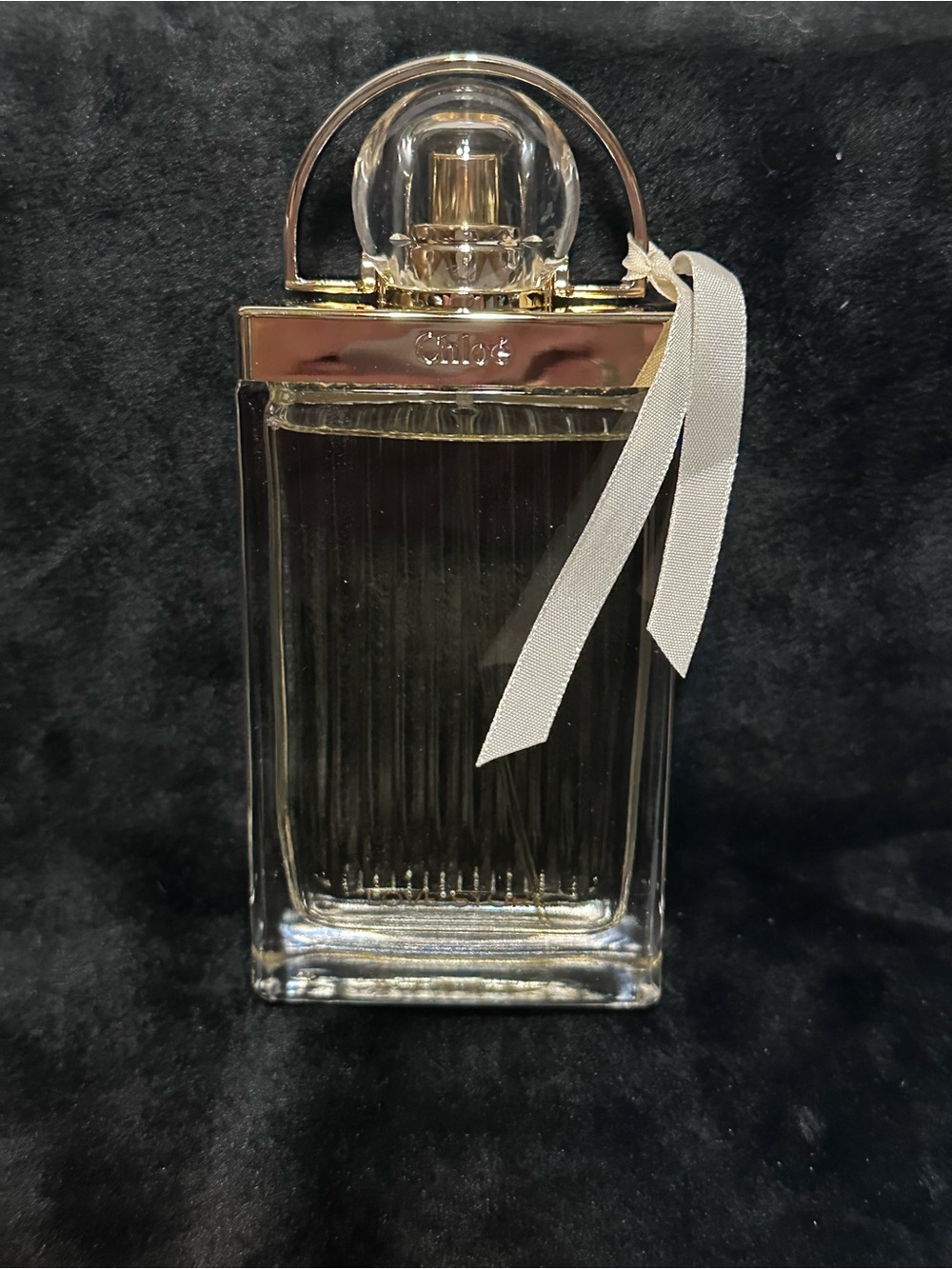 Chloé Glass Perfume Bottle with Gold Accents and White Ribbon